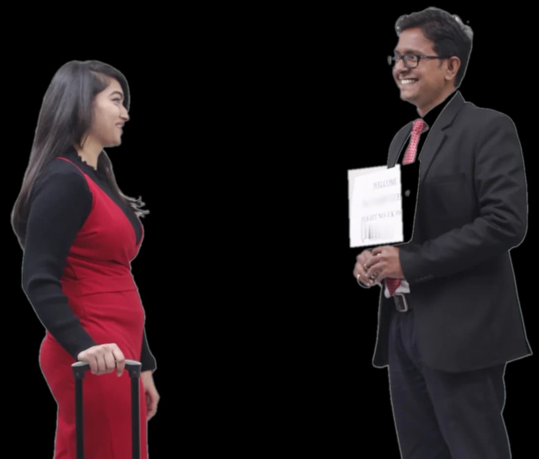 An Elite World Services greeter meets a traveller wheeling a cabin suitcase, ready to take the bag from her
