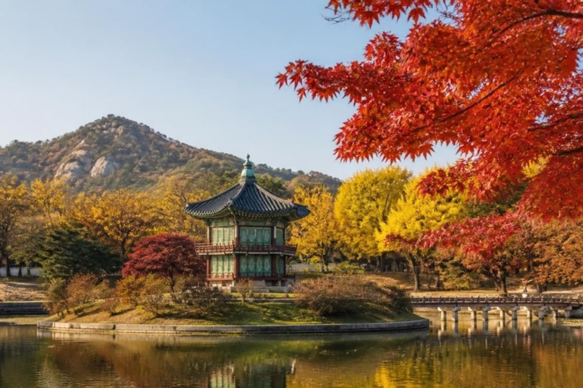 Red and golden maples around a pavilion on a pond in Seoul in autumn